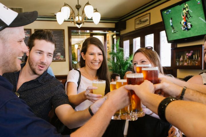 a group of people holding wine glasses