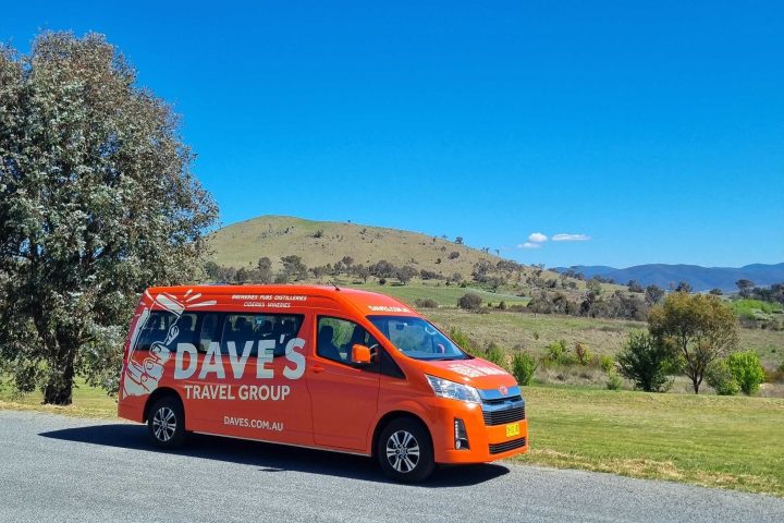 a large orange truck in a field