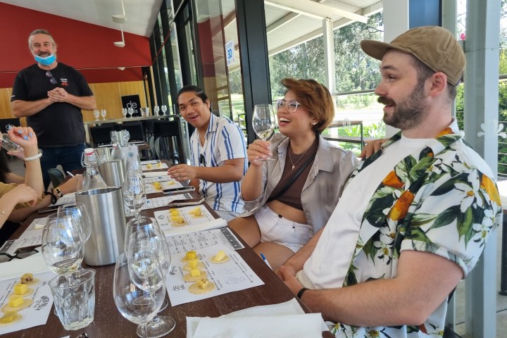 a group of people sitting at a table eating food