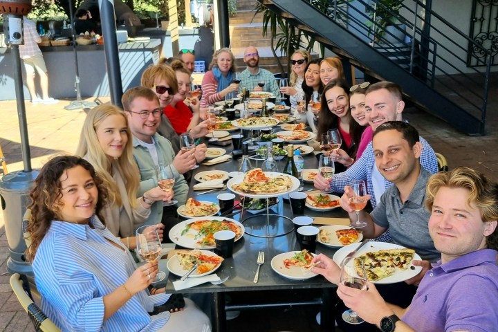 Pauline Ducruet et al. sitting at a table eating food
