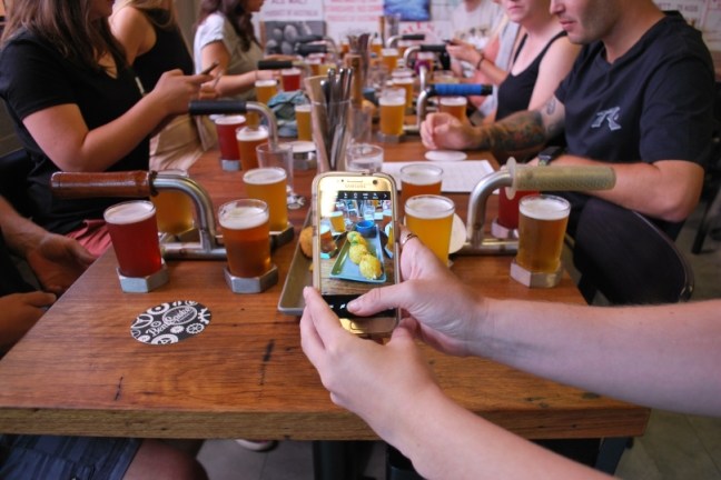 a group of people sitting around a wooden table