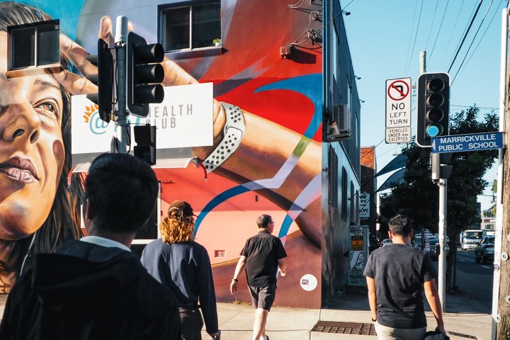 a man standing next to a traffic light