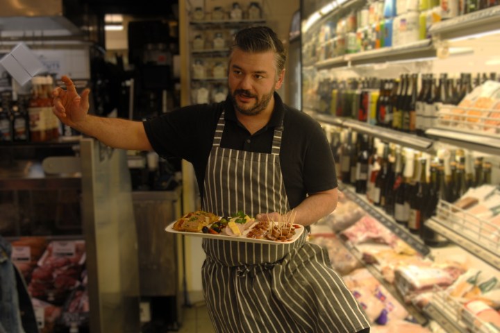a person standing in a kitchen preparing food