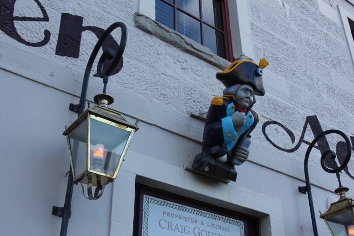 a clock hanging from the side of a building
