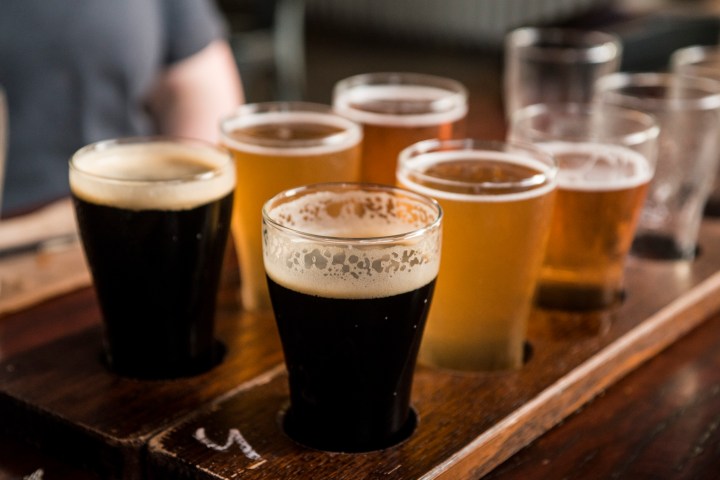 a cup of coffee and a glass of beer on a table